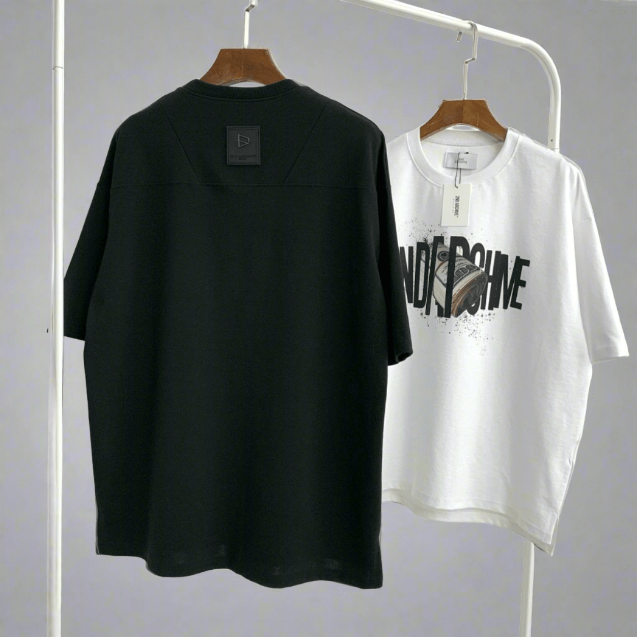 Back facing black t-shirt and white front facing t-shirt.