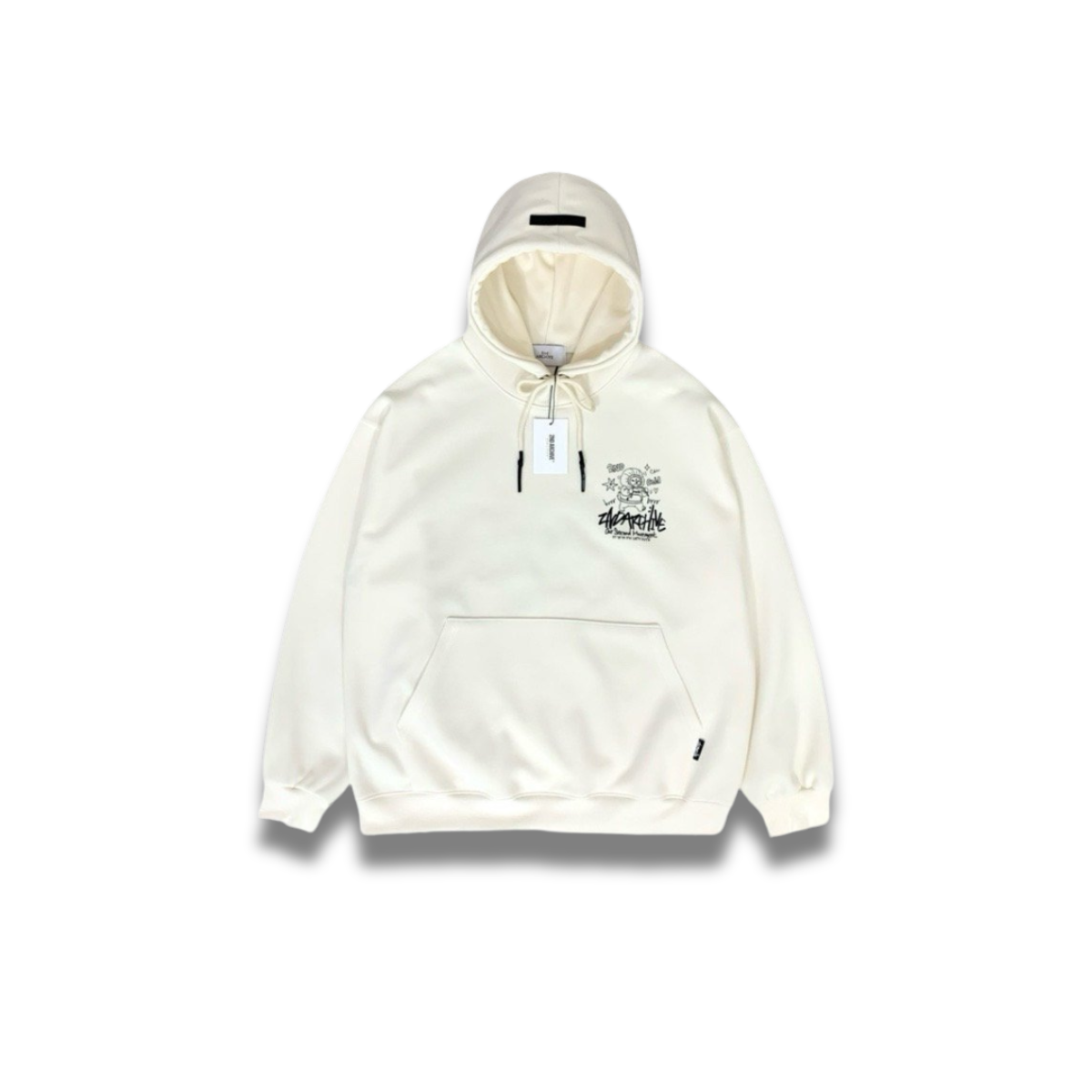 クリーム色パーカーの胸元に描かれたかわいいコーギーグラフィックのアップ