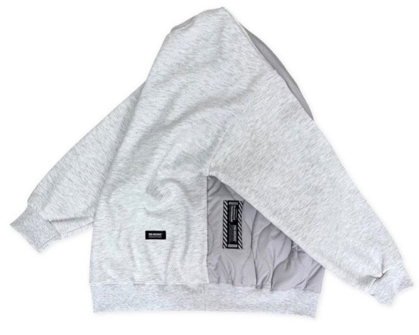 Side facing light gray hoodie sweater with back padding. 