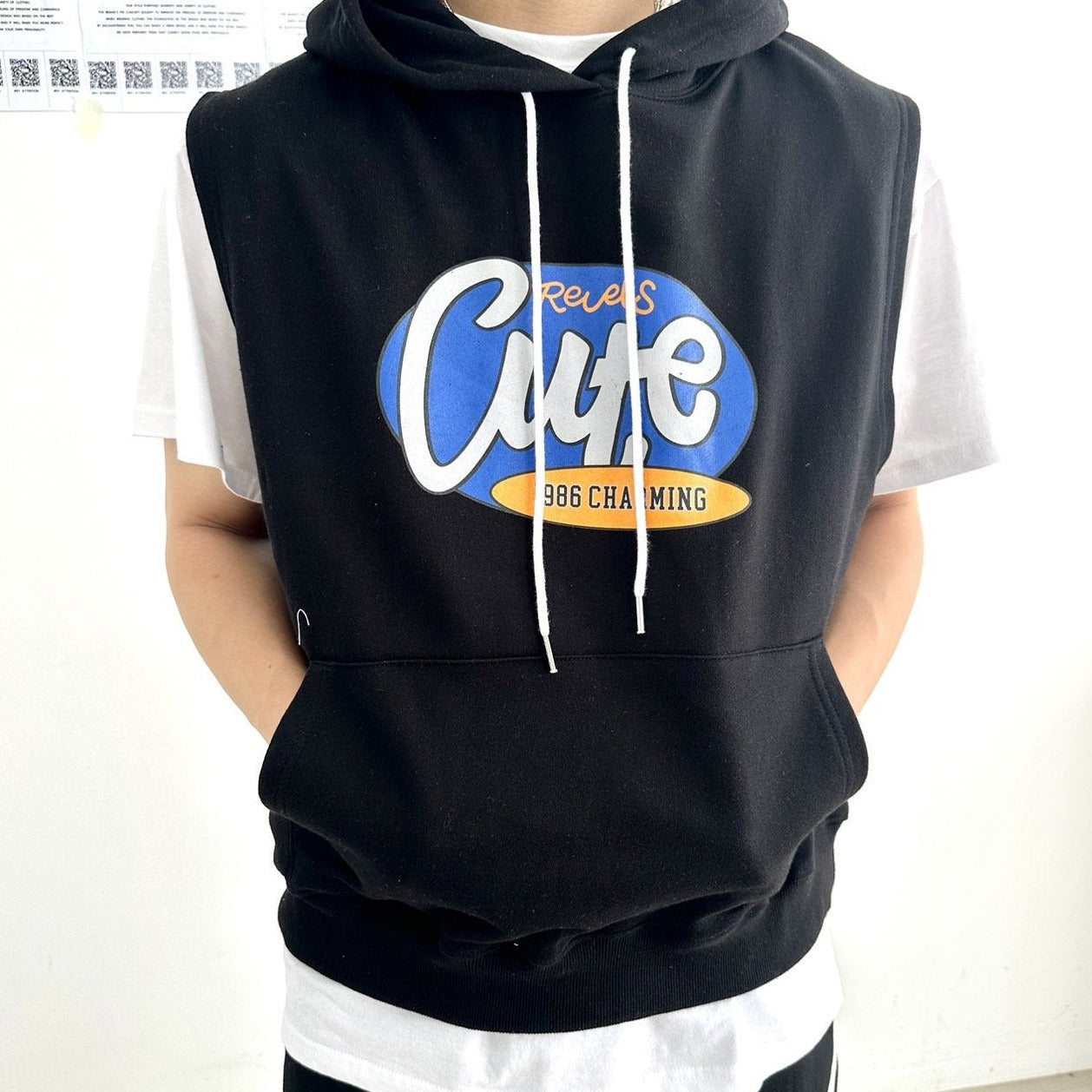 Close up of the text "Cute" printed on a black hoodie. 