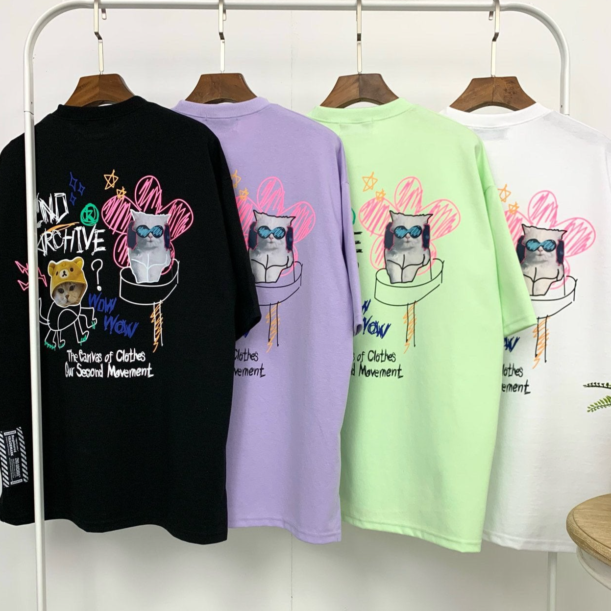 Back view of four t shirts made in Korea by 2nd archive brand with cute cat graphics. 