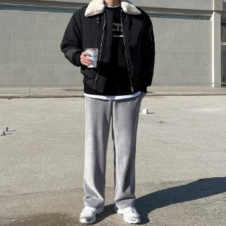 Korean model standing outside wearing gray fashionable pants.  