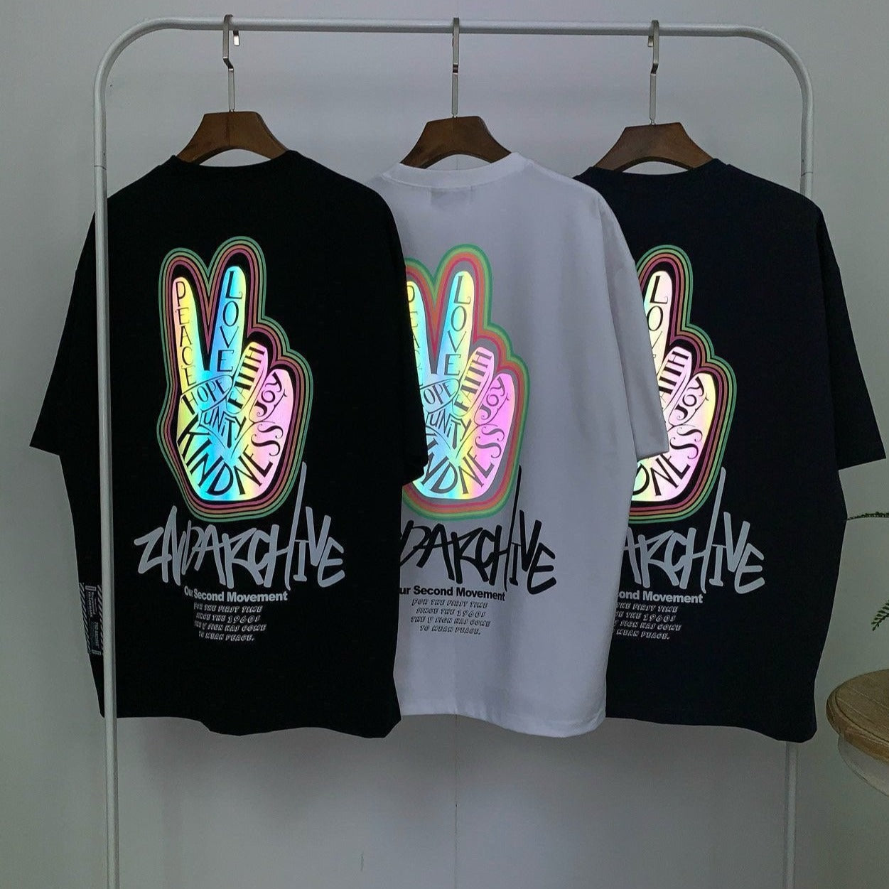 Three Korean made graphic street fashion t shirts hanging on a rack.