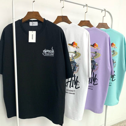 black, white, purple and light blue Korean fashion t-shirts with graphics hanging on a rack.  