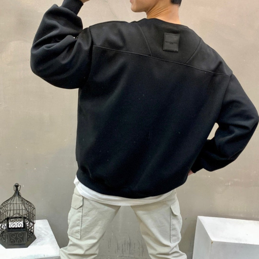 Korean model posing in black sweater showing back facing. 