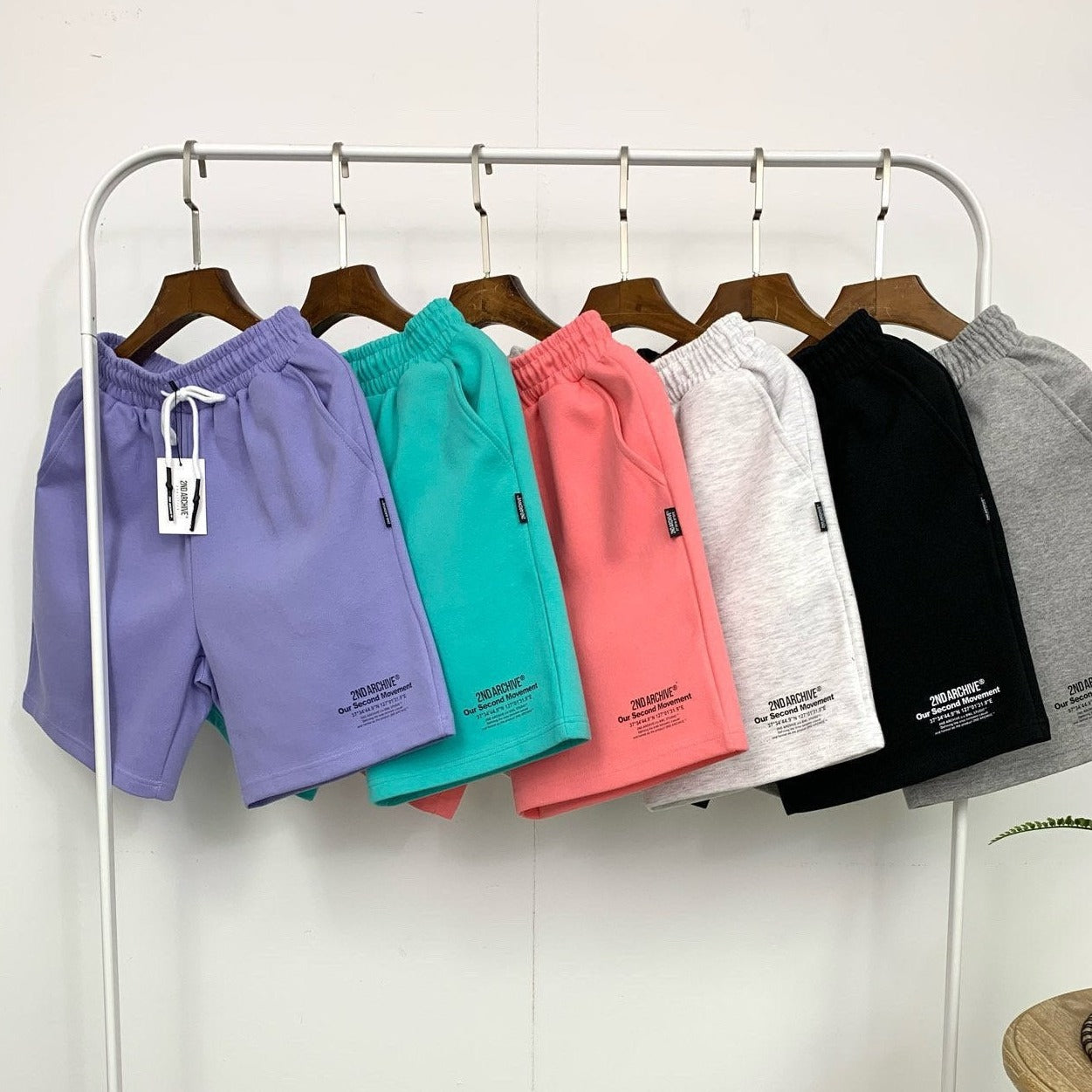 six pairs of shorts hanging on a rack made in Korea. 