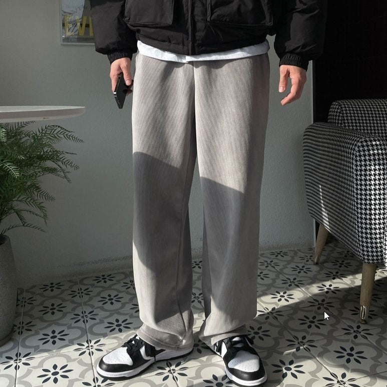 Model wearing microfiber interior gray pants standing in a room. 