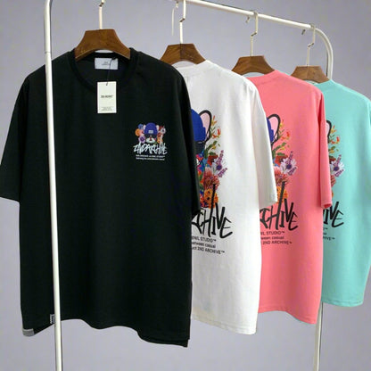 Four graphic street fashion t shirts hanging on a rack. 