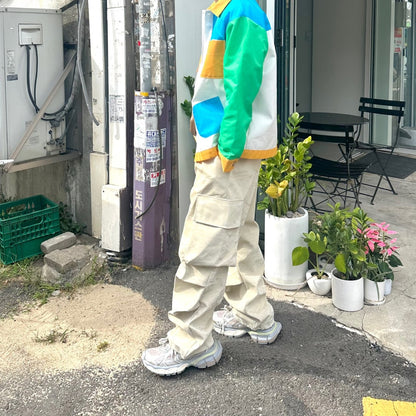 Beige cargo pants with double knee folds.