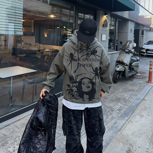 Khaki hoodie with spider web graphic.