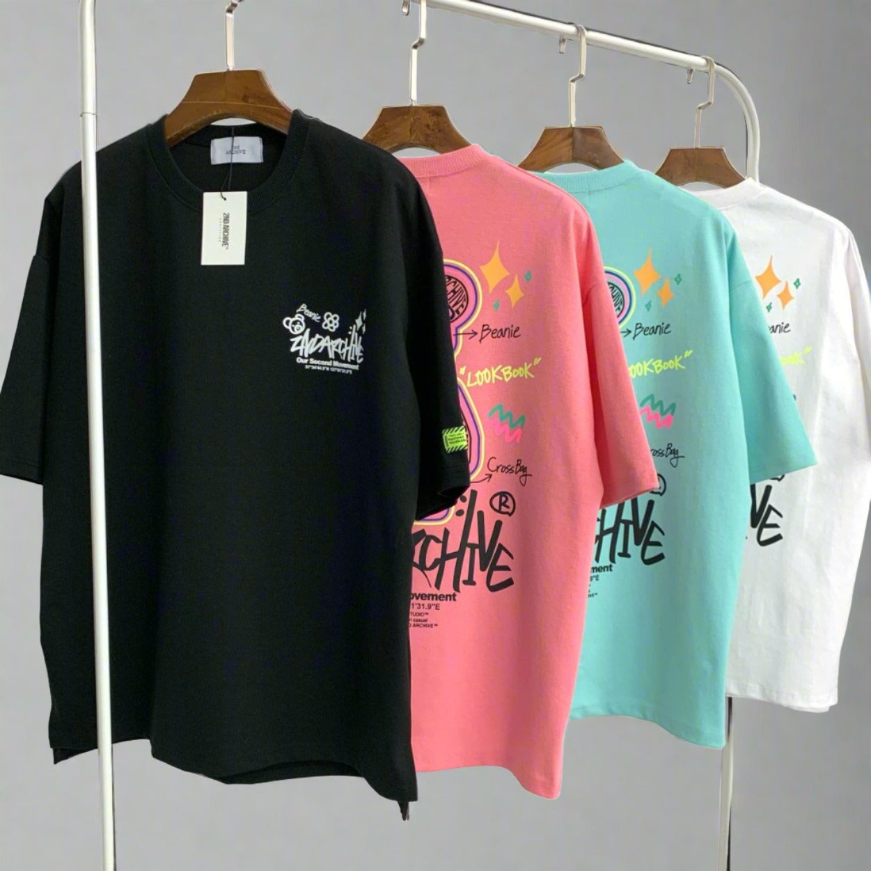 Four Korean street fashion graphic t shirts hanging on a rack. 