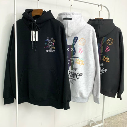 Black, light gray, dark gray street fashion hoodie sweaters hanging on rack.