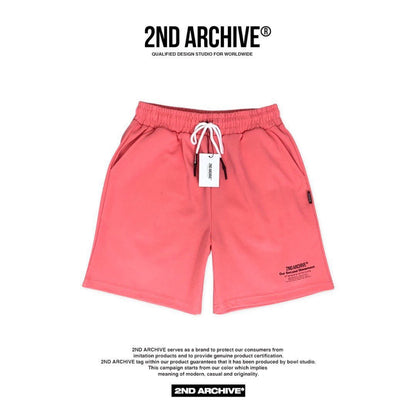 Front facing coral colored adjustable waist band shorts made in Korea. 