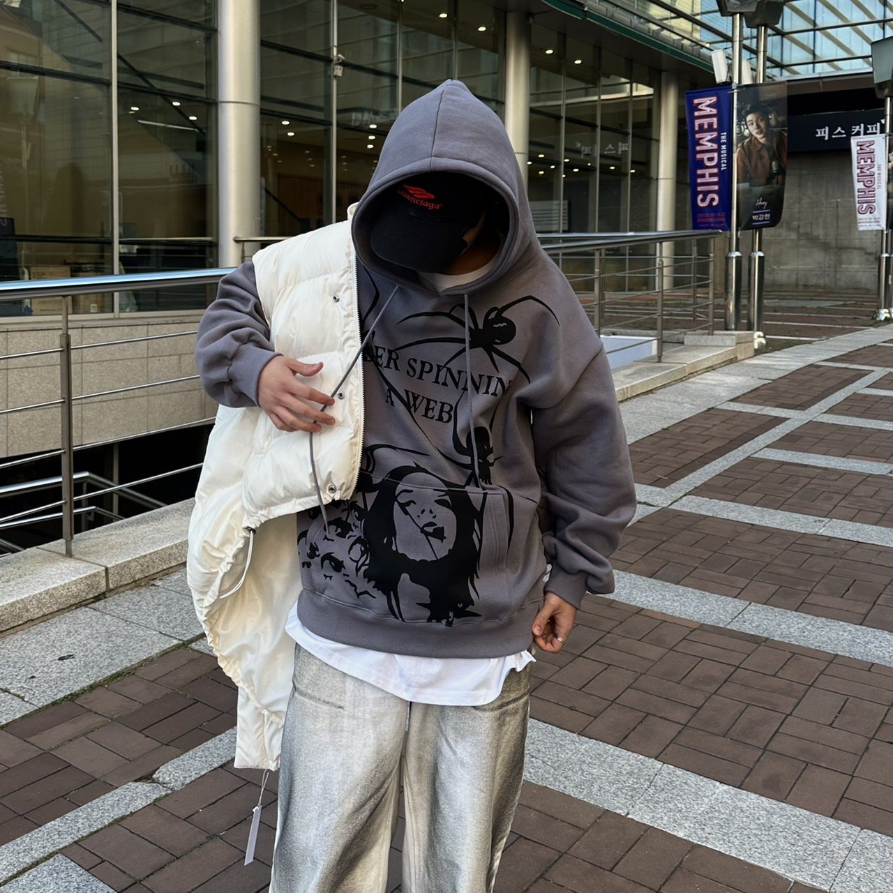 Gray hoodie with spider web detail.