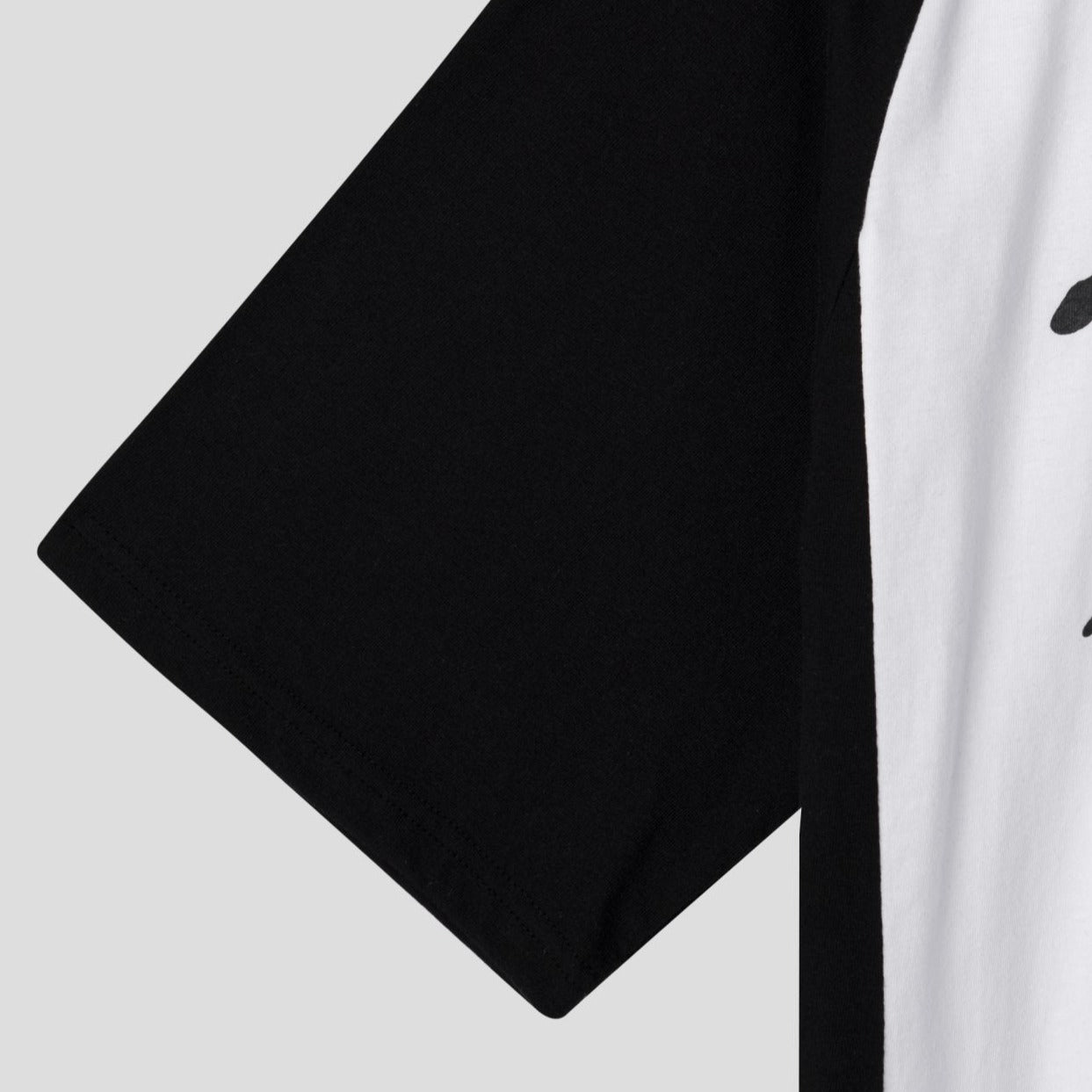 two-tone sleeve close up of baseball jersey style shirt. 