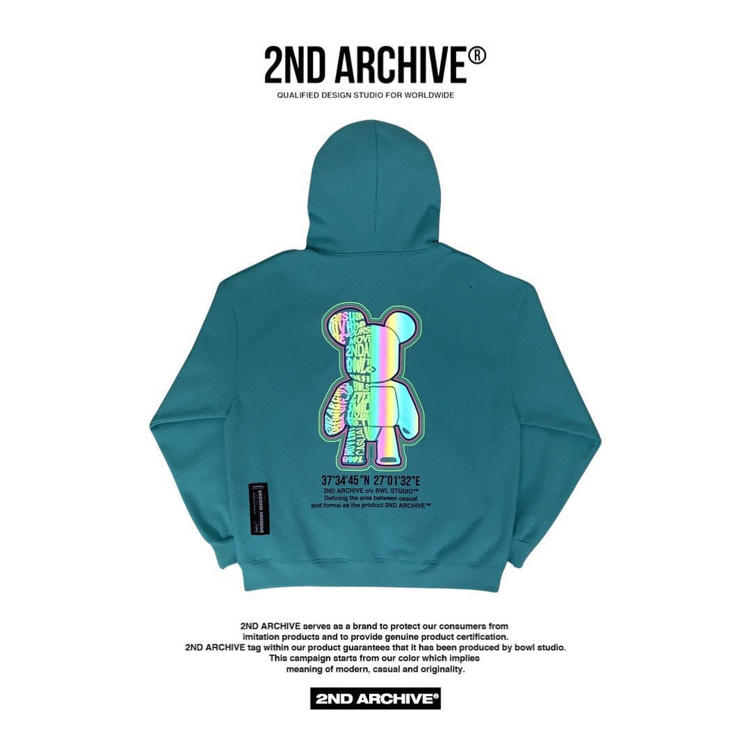 Back facing mint parka with reflective street fashion graphic of a bear.