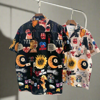 Two graphic pop art shirts hanging on a rack from 2nd Archive. 