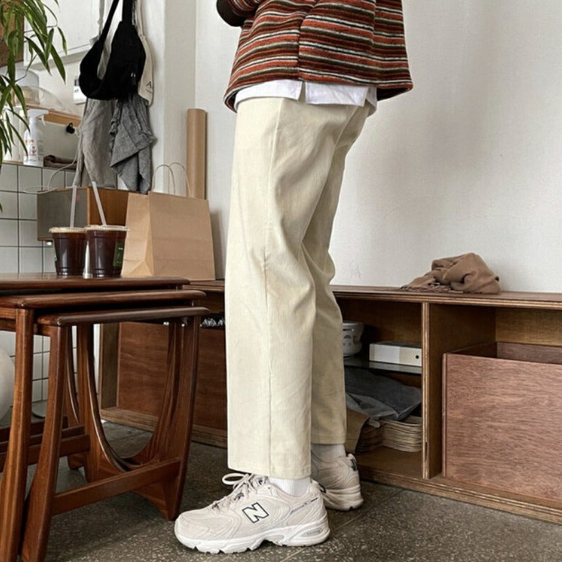 Fashion model standing in room with trendy pants on. 