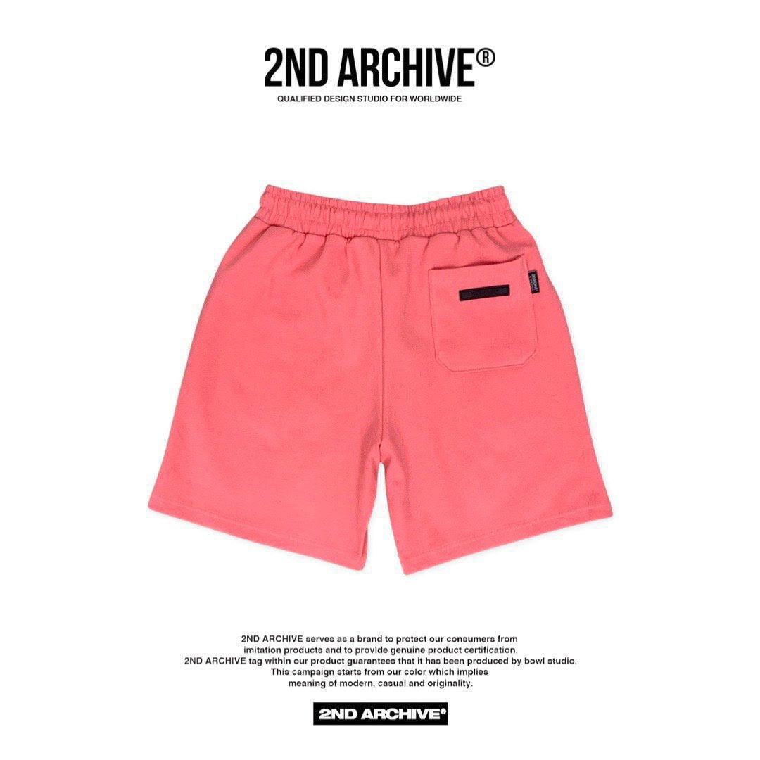 Unisex salmon colored back facing shorts with pocket.