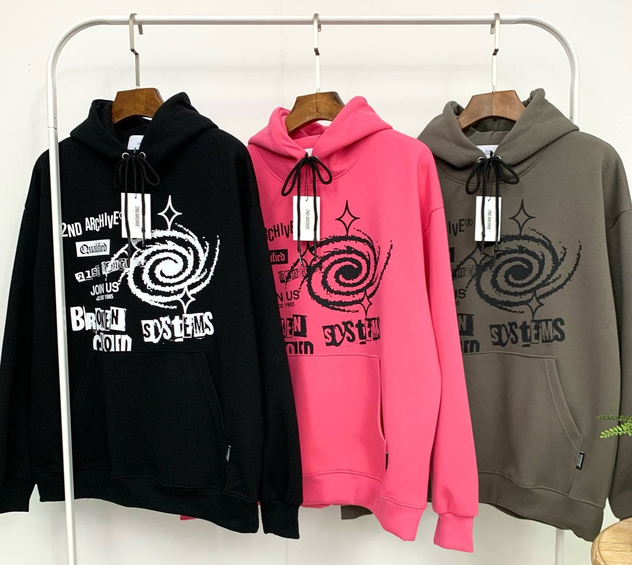 Extra warm sweaters hanging on rack with three color options. 