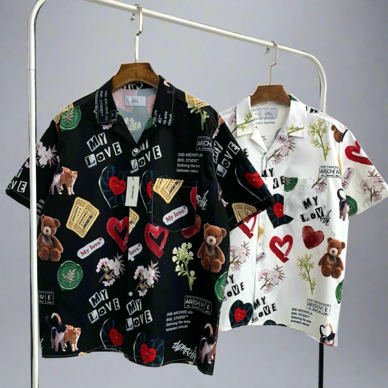 Side view of black and white graphic art button up shirts Hawaiian style. 