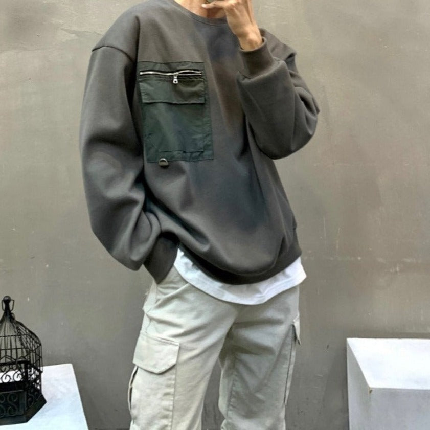 Korean model posing in Khaki street fashion sweater with front zip pocket. 